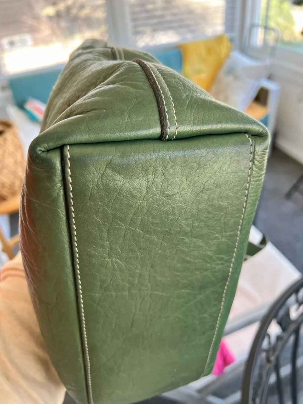 Tramontano hand bag in a pebbled green with a slight shimmer. Magnetic closure.